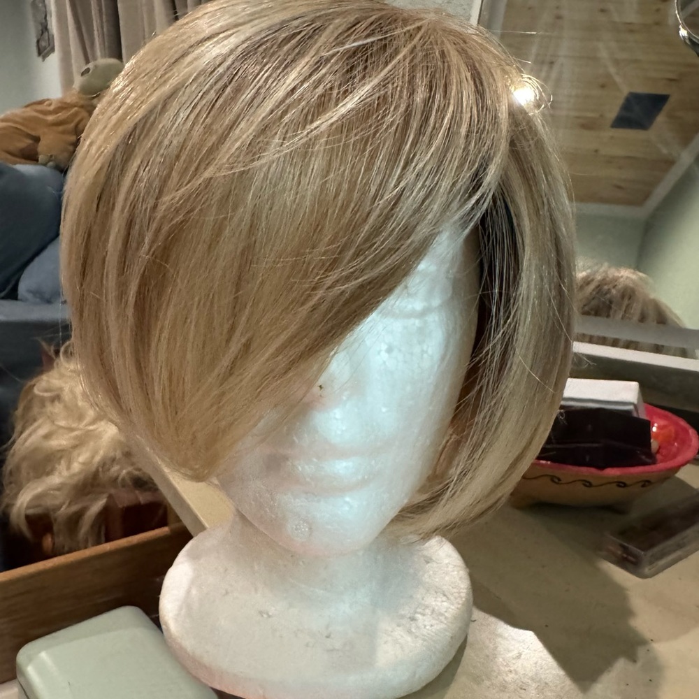 Jon Renau brand. Light highlighted blonde rooted short wig. Good condition.
